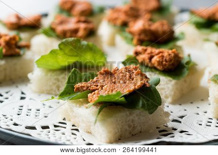 Canape With Muhammara, Adjika, Ajika Or Acuka On Small Square Breads With Round Plate.