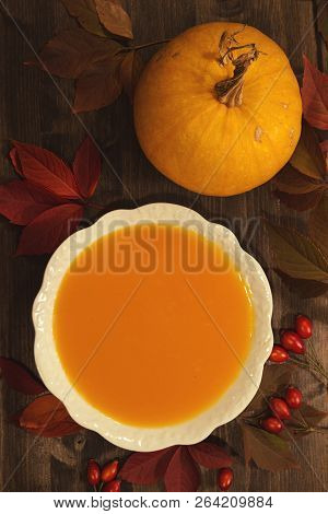 Pumpkin Soup On Wooden Background - Top View
