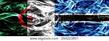 Algeria, Algerian Vs Botswana, Botswanan Smoke Flags Placed Side By Side. Concept And Idea Flags Mix