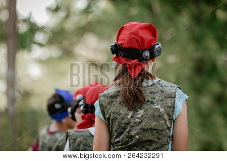 Active Kids Playing Military Shooting Game In Forest