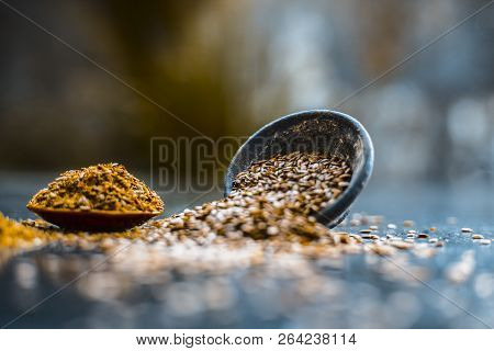 Close Up Of Ayurvedic Herb Alsi Or Adsi Or Flax Seed In A Black Colored Clay Bowl With Its Powder On