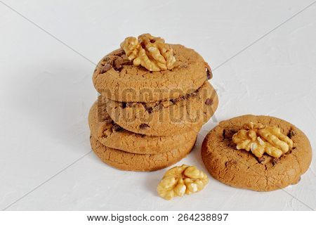 Walnuts And Delicious Sweet Crunchy Shortbread With Raisins And Dark Chocolate. Light Concrete Backg