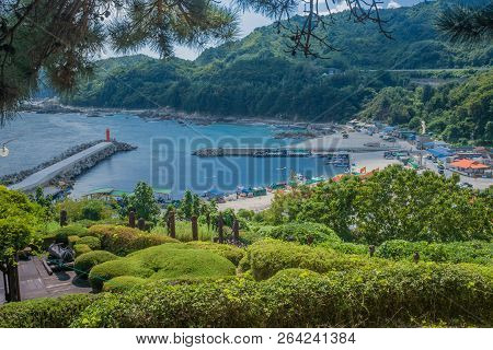 Samcheok, South Korea; September 25, 2018: Coastal Ocean Village And Pier Below Public Garden With P