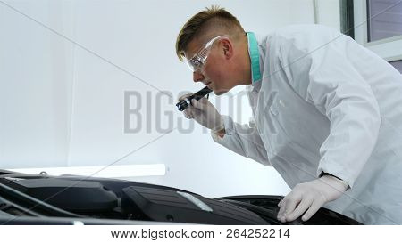 Professional Master After Polishing And Painting Cars, Checks The Flashlight Scratches, A Respirator