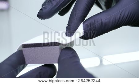 A Young Professional Master Holds A Jar In A White Coat, Safety Goggles, White Rubber Gloves.