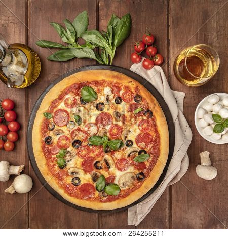 Overhead Photo Of Pepperoni Pizza With Glass Of White Wine, Olive Oil, Basil Leaves, Mushrooms, Cher