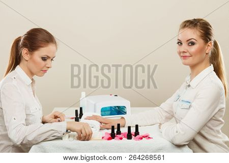 Relaxing Time And Wellness Day Concept. Blonde Elegant Woman Visiting Professional Manicurist Salon.