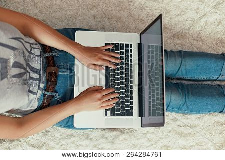 The Concept Of Blogging, Working On A Laptop. Using A Laptop Sitting On Floor. Modern Technologies..