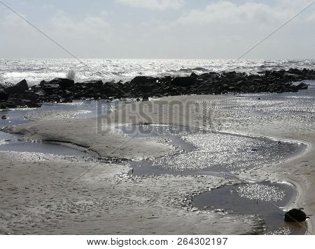 On A Dreary Day At Driftwood Beach On The Barrier Island Of Jekyll Island, Georgia, Waves Are Crashi
