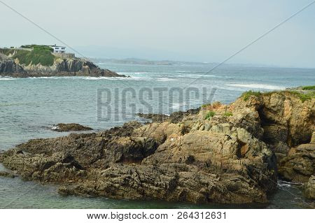 Bay With The Waves Breaking On Its Rocks In The Background A House Hidden Among The Rocks In Tapia D