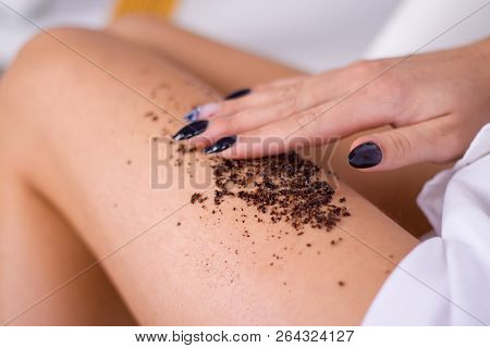Closeup Woman Legs With Coffee Massage Scrub. Cosmetology, Grooming, Spa Cosmetic Products, Beauty A