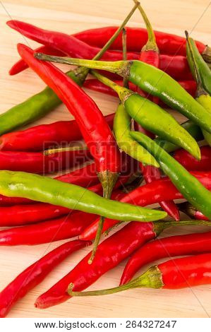 Many Pods Of Long Chili Peppers Green Red Contrasting Fruits Base Bright Contrasting On A Wooden Bas