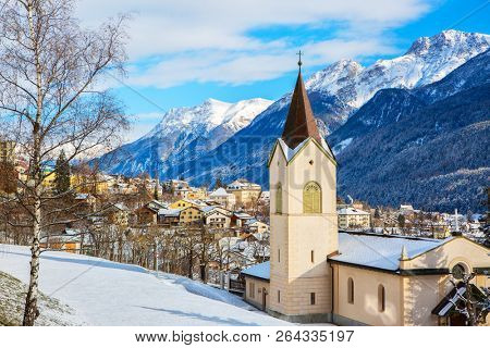 Scenic view on Scuol village and valley on a sunny winter day, Lower Engadine, Switzerland.
