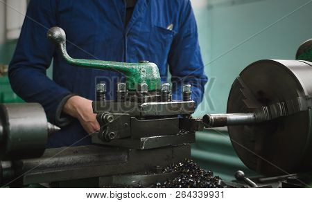 Turner Worker Is Working On A Lathe Machine In A Factory.