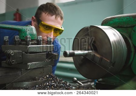 Turner Worker Is Working On A Lathe Machine In A Factory.