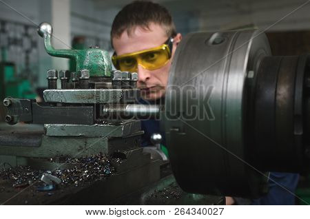 Turner Worker Is Working On A Lathe Machine In A Factory.