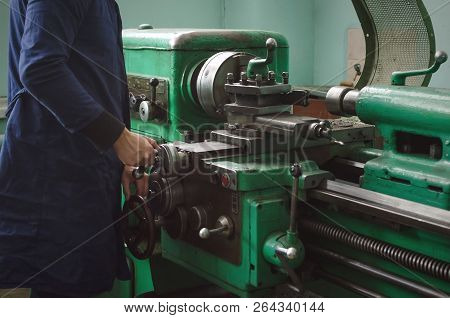 Turner Worker Is Working On A Lathe Machine In A Factory.