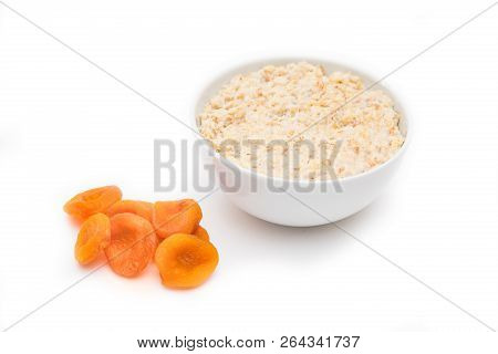Oatmeal With Dried Apricots In White Bowl On White Bakcground. Isolated On White. Healthy Food