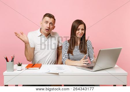 Two Young Tired Business Woman Man Colleagues Sit Work At White Desk With Contemporary Laptop Isolat