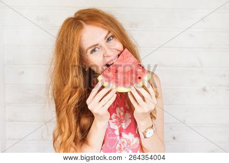 Red-hair Woman Is Tasting A Slice Of Watermelon