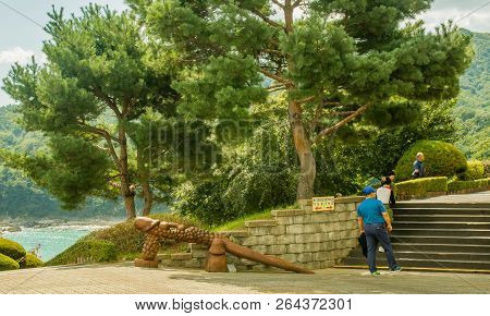 Samcheok, South Korea; September 25, 2018: Unidentified Koreans Walking On On Stairs Next To Phallic