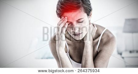 Highlighted pain against beautiful brunette suffering from head ache 