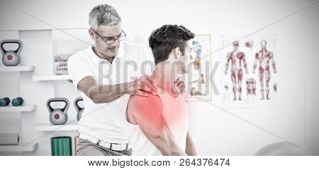 Highlighted pain against physical therapist examining patient shoulder