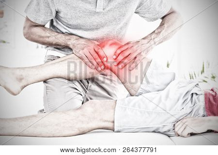 Highlighted pain against male physical therapist massaging patient knee