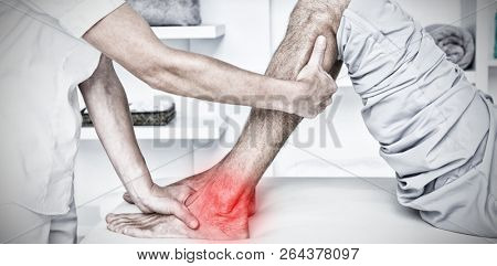 Highlighted pain against cropped image of hand examining calf muscle