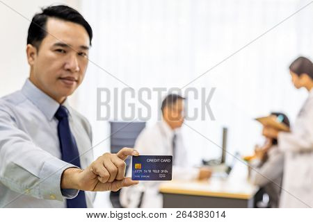 Portrait of Young adult Patient with credit card with examination room medical office background for insurance concept