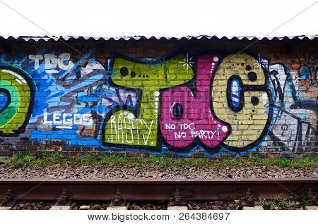 Full And Acomplished Graffiti Artwork. The Old Wall Decorated With Paint Stains In The Style Of Stre