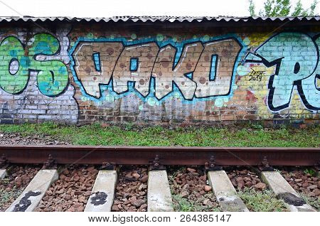 Full And Acomplished Graffiti Artwork. The Old Wall Decorated With Paint Stains In The Style Of Stre