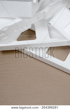Background Image With Beige Cardboard Paper And Styrofoam Boxes Disgarded As Rubbish. The Concept Of