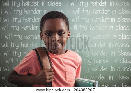 Punishment lines against portrait of boy with backpack and books against greenboard