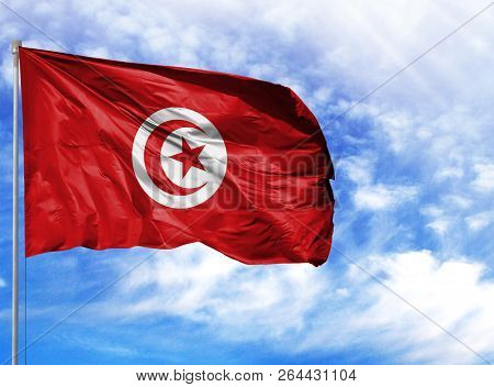 National Flag Of Tunisia On A Flagpole In Front Of Blue Sky