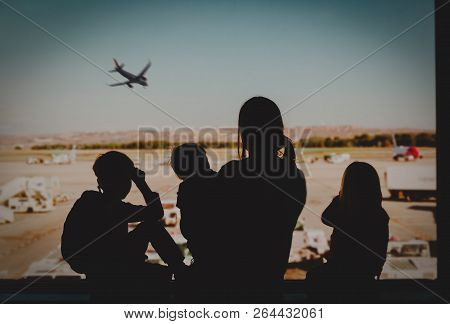 Family Travel- Mother With Kids Looking At Planes In Airport
