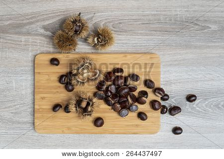 Some Mature Chestnuts On The Wooden Table