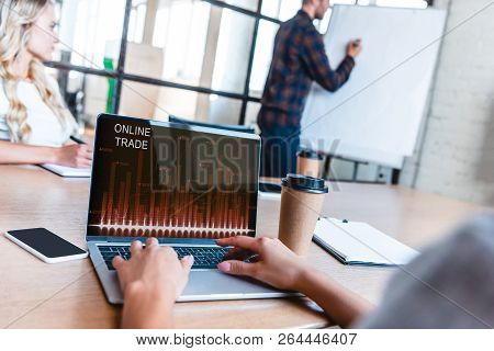Cropped Cropped Shot Of Business Person Using Laptop With Online Trading Website On Screen During Me