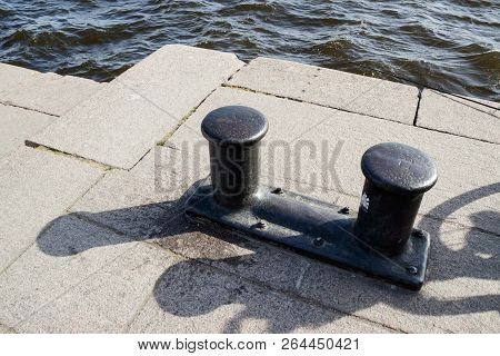 Black Mooring Cleats On The Pier Of The Port