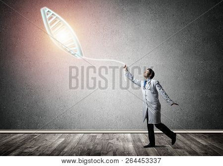 Conceptual Image Of Successful And Young Doctor In White Uniform Interracting With Dna Structure Whi