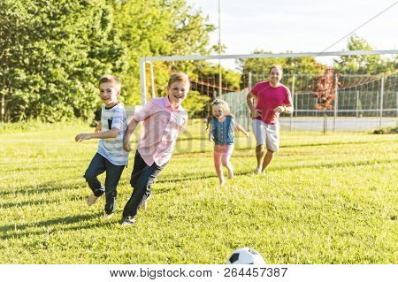 Nice Happy Family Lifestyle Play Soccer Outside