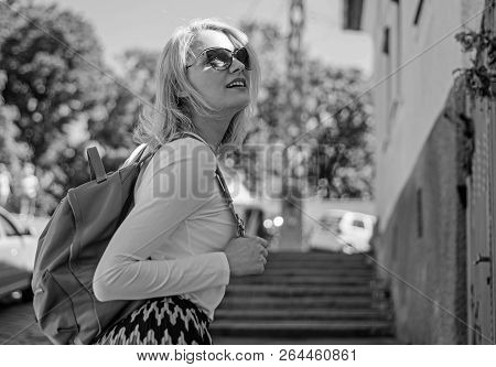 Urious Tourist. Trendy Girl Walking. Woman Carrying Backpack While Standing Outdoors. Girl With Styl