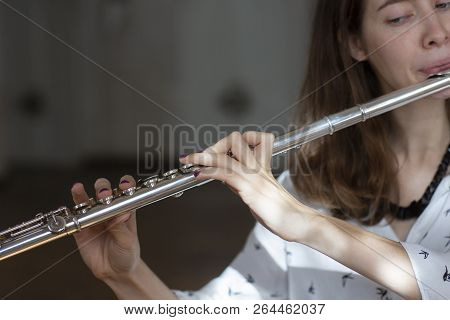 Girl Plays On Flute. Flute In Hands Of Girl During The Concert. Professional Musician Playing On Flu