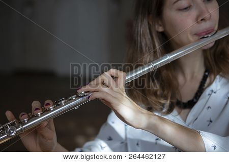 Girl Plays On Flute. Flute In Hands Of Girl During The Concert. Professional Musician Playing On Flu