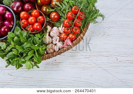 Vegetables Assorted In A Large Basket On A White Desk