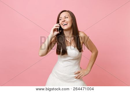 Portrait Of Joyful Bride Woman In White Wedding Dress Talking On Mobile Phone Receiving Congratulati