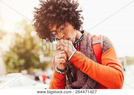 Young Fashionable Dressed Curly Black African American With Glasses Walks Through The Streets Agains