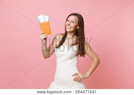 Smiling Happy Bride Woman In White Wedding Dress Holding Passport And Boarding Pass Ticket, Going Ab
