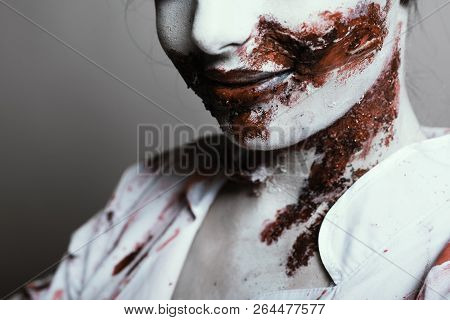 Scary Damaged Girl In Nurce Halloween Costume Looking Like Zombie