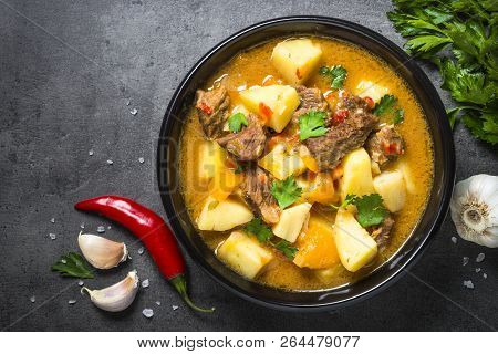 Goulash With Meat And Vegetables On Black Background. Beef Stew With Vegetables. European Cuisine. T